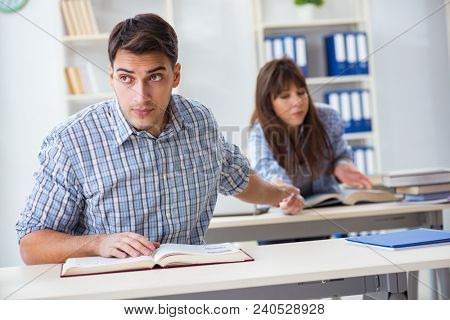 Students sitting and studying in classroom college