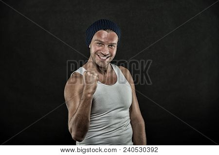 Macho On Smiling Face With Strong Muscles Look Brutal, Black Background. Man With Muscular Arms Sque