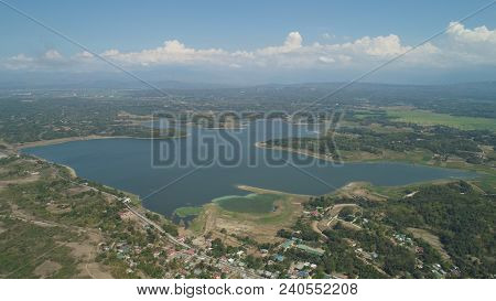 Aerial View Of Paoay Lake Against Background Of Mountains And Sky With Clouds. Paoay Lake National P