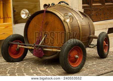 Uncommun Old Toy Car With Wooden Barrel On A Street