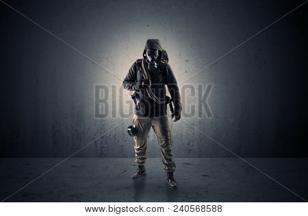 Bad agent in a dark room with arms on his hand and gas mask