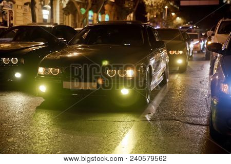 Night View Of The Cars. At The Night With Yellow And Red Electrical Light For Cars During They Are C