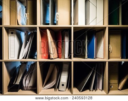 Books And Folders With Documents Are On The Shelf