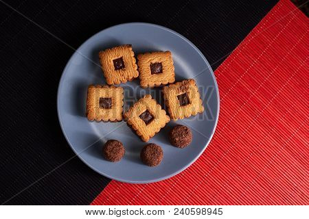 Chocolate Cookies On Gray Plate On Red And Black Table