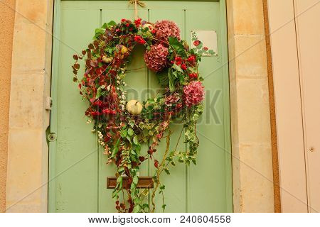 Multi-colored Wreath With Hydrangeaon And Ivy On A Wooden Door
