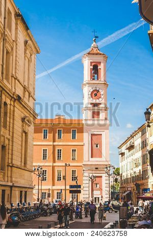 Nice, France - October 13, 2009: Street With Open Air Cafe Leading To Colourful Red And Pink Bell To