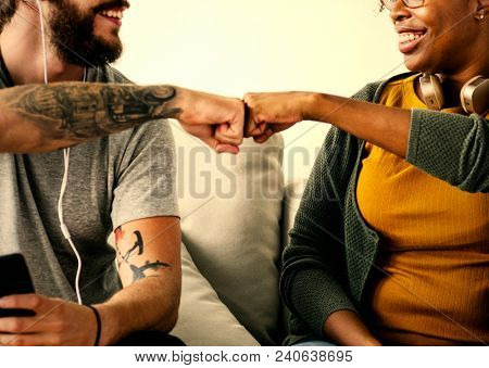 Happy friendly couple fist bumping