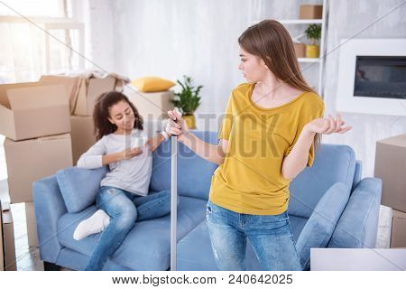 Stop Being Lazy. Irritated Young Girl Cleaning The Floor In The New Apartment And Scolding Her Roomm