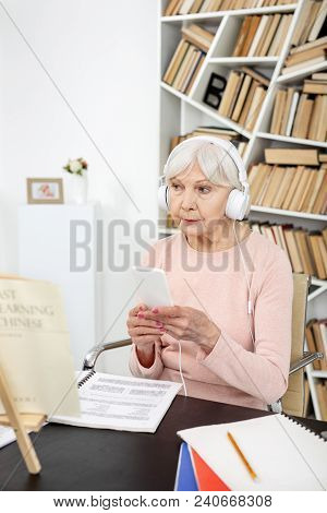 Listening Skills. Attractive Mature Woman Listening To Audio And Holding Phone