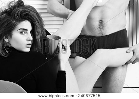 Pretty Cute Sexy Brunette Girl Holding Pink Cup Or Mug In Black Bodysuit Sitting On Orange Chair And