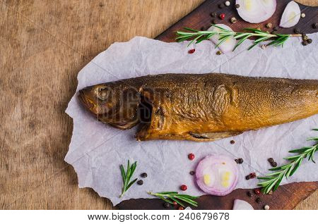 Smoked Whole Fish With Spices On Wooden Background. Selective Focus.