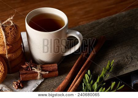 Traditional Christmas Tea Concept With A Cup Of Hot Tea, A Large Set Of Cookies On A Homespun Napkin