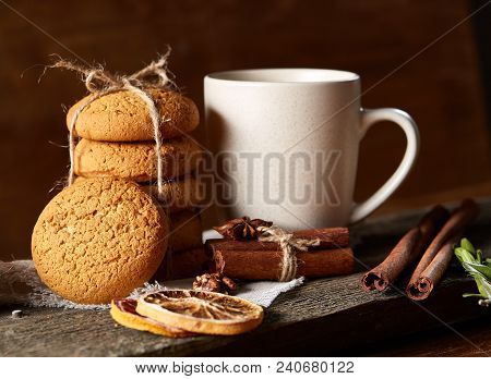 Traditional Christmas Tea Concept With A Cup Of Hot Tea, A Large Set Of Cookies On A Homespun Napkin