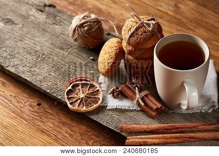 Traditional Christmas Tea Concept With A Cup Of Hot Tea, A Large Set Of Cookies On A Homespun Napkin