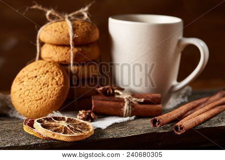 Traditional Christmas Tea Concept With A Cup Of Hot Tea, A Large Set Of Cookies On A Homespun Napkin