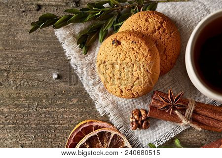 Traditional Christmas Tea Concept With A Cup Of Hot Tea, A Large Set Of Cookies On A Homespun Napkin