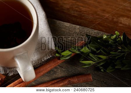 Traditional Christmas Tea Concept With A Cup Of Hot Tea, A Large Set Of Cookies On A Homespun Napkin