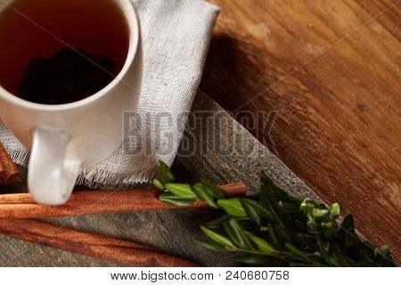 Traditional Christmas Tea Concept With A Cup Of Hot Tea, A Large Set Of Cookies On A Homespun Napkin