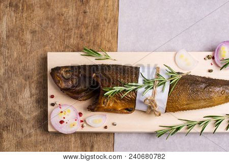 Smoked Whole Fish With Spices On Wooden Background. Selective Focus.