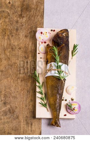 Smoked Whole Fish With Spices On Wooden Background. Selective Focus.