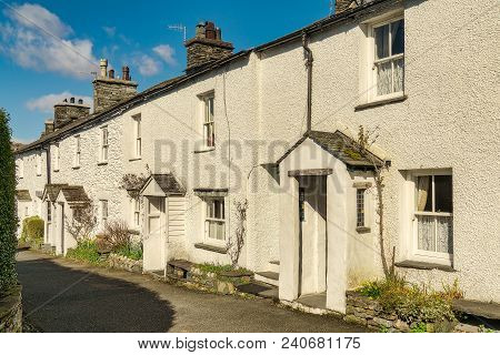 A Row Of Whitewashed Cottages On A Sunny Day In Ambleside, The English Lake District.