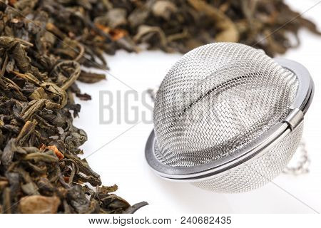 Tea Strainer On A Chain, With A Mixture Of Dry Green Large-leaf Tea With Soursop, Isolated On A Whit