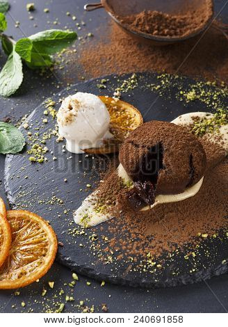 Classic French Dessert. Warm Chocolate Fondant Lava Cake With Custard And Vanilla Ice Cream On Slate