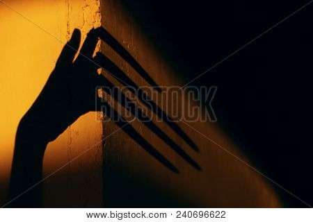 Strange Shadow On The Wall.terrible Shadow. Abstract Background. Black Shadow Of A Big Hand On The W