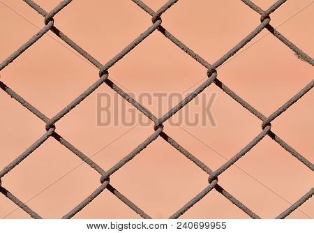 A Fence Made Of Iron Net.the Wire Is Twisted Into A Rigid Mesh .