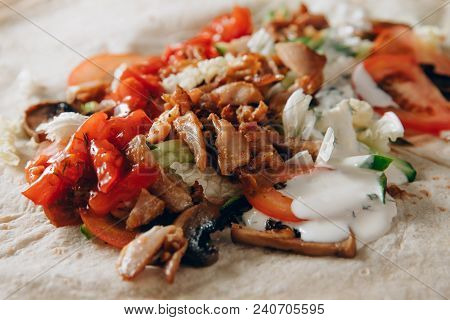 Close-up Shawarma Sandwich Chicken Roll In Pita With Fresh Vegetables