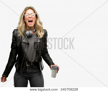 Young student woman with headphones stressful, terrified in panic, shouting exasperated and frustrated. Unpleasant gesture. Annoying work drives me crazy
