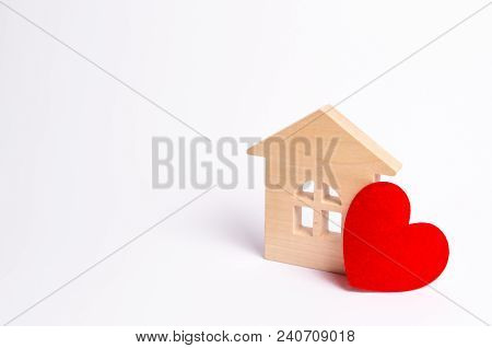 Wooden House With A Red Heart On A White Background. Love Nest, Love Relationships. Buying A House W