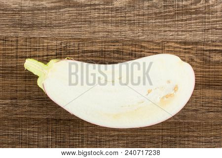 One Striped Purple Eggplant Half Top View Isolated On Brown Wood Background Cross Section