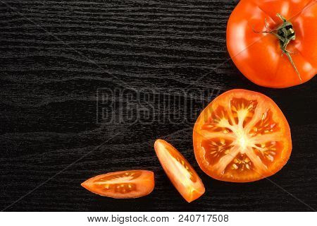 Red Tomato Collection Isolated On Black Wood Background Top View One Whole One Section Half And Two 