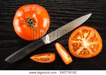 Red Tomato Composition With A Knife Isolated On Black Wood Background Top View One Whole One Section