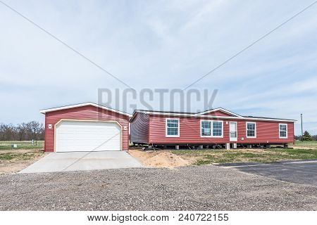 New Manufactured Home With Red Vinyl Siding And Windows With White Lineals Still Needs Some Work