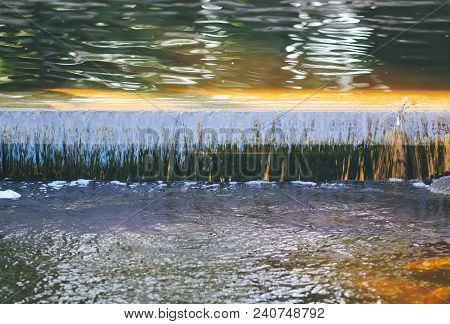 Cold Transparent Water Of Decorative Artificial Waterfall In Summer Park.