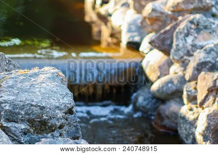 Cold Transparent Water Of Decorative Artificial Waterfall In Summer Park.