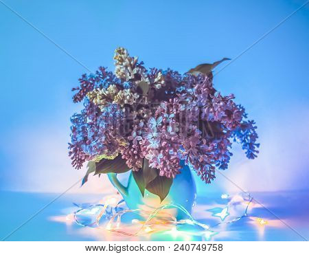Beautiful Bouquet Of Fragrant Purple Flowers In Blue Ceramics Vase On Light Background With Festive 
