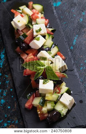 Greek salad with feta cheese cubes and fresk vegetables