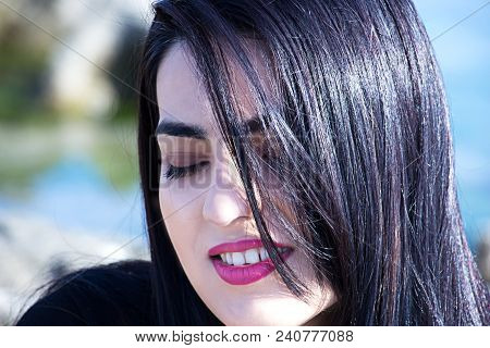 Happy Woman On The Beach. Portrait Of A Beautiful Girl Close-up. Spring Portrait On The Beach. Young