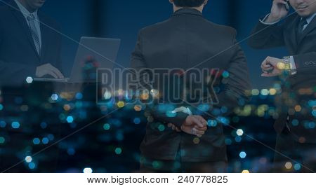 Double Exposure Of Businessman Group Standing And Working In Night Office Over The Cityscape Phoro B