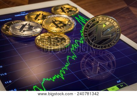 Cryptocurrency Metal, Focus On Litecoins On Tablet Screen That Showing Green Price Or Stock Market P