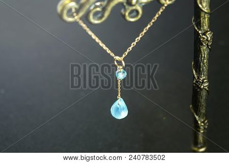 Golden Necklace With Apatite With Green Chalcedony With Blue Topaz On Black Background.close Up.