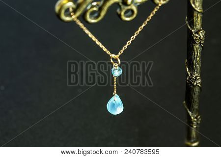 Golden Necklace With Apatite With Green Chalcedony With Blue Topaz On Black Background.close Up.