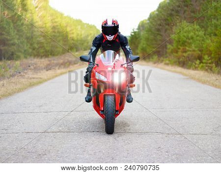 Krasnoyarsk, Russia - April 21, 2018: Beautiful Motorcyclist In Full Gear And Helmet On A Red And Bl