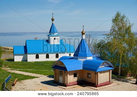 A Small Church Painted With Blue Paint On The Background Of The Sea And Blue Sky On A Sunny Day.