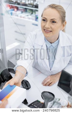 Symptoms Relive. Top View Of Pleasant Female Pharmacist Stretching Medication And Smiling
