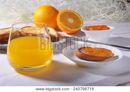 Morning Breakfast Set With Orange Jam On Bread Toast And Juice In Glass