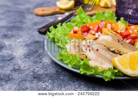 Fish Fillet With Raw Vegetables And Lemon In A Dish On The Table. Selective Focus.
